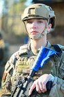Airman stands with protective equipment during BATTLE school.