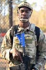 Airman stands with protective equipment during BATTLE school.
