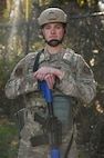 Airman stands with protective equipment during BATTLE school.