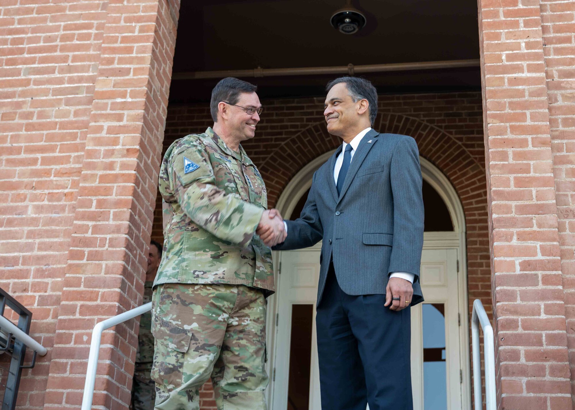 Chief of Space Operations Gen. Chance Saltzman shakes hands with the  University of Arizona president, Suresh Garimella, in Tucson, Arizona, Feb. 27, 2025. During his visit, Saltzman met with University of Arizona leadership and Reserve Officer Training Corps cadets. (U.S. Air Force photo by Senior Airman William Finn V)