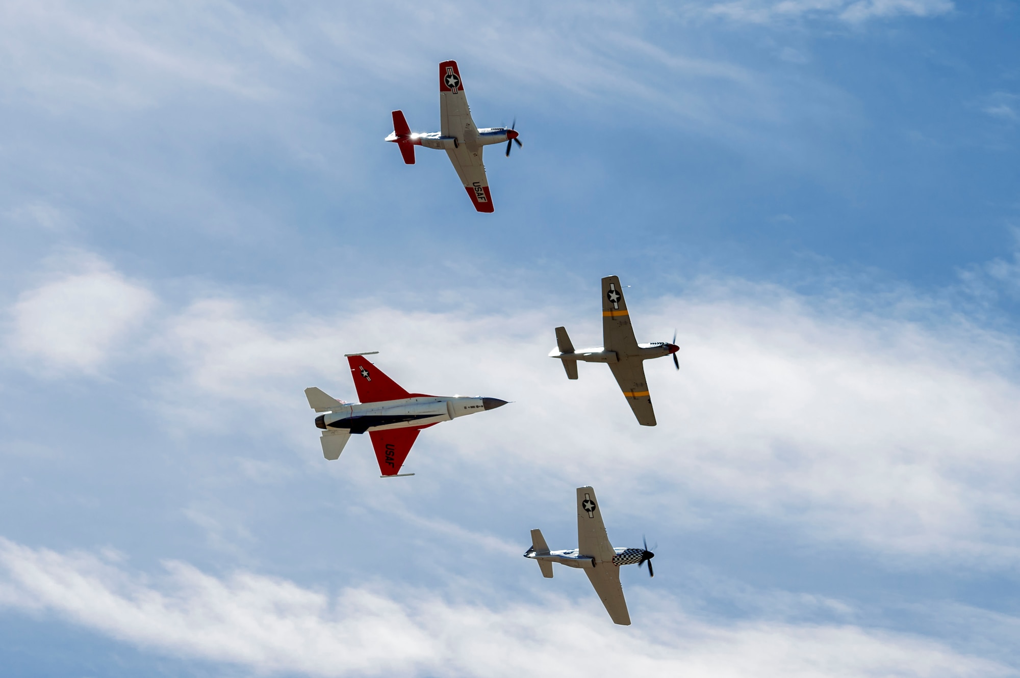 A U.S. Air Force F-16 Fighting Falcon flies in formation with three P-51 Mustang aircraft during Heritage Flight Training Course at Davis-Monthan Air Force Base, Arizona, Feb. 28, 2025. The Air Combat Command demonstration teams regularly fly with heritage aircraft, showcasing U.S. air combat capabilities over the last 75 years. (U.S. Air Force photo by Airman Samantha Melecio)