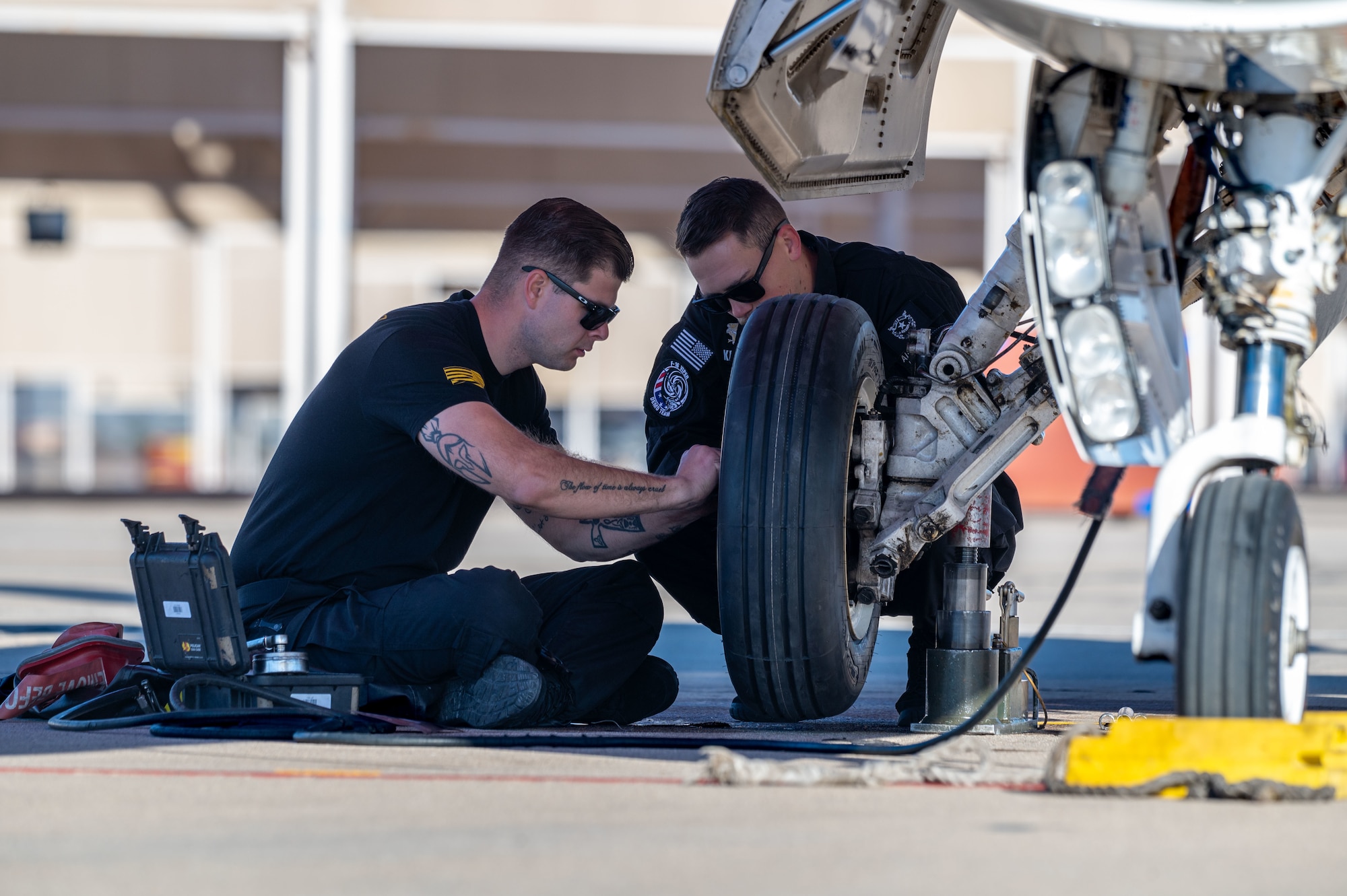U.S. Air Force F-16 Viper Demonstration Team members perform maintenance on an F-16 aircraft during the Heritage Flight Training Course at Davis-Monthan Air Force Base, Arizona, Feb. 28, 2025. The team routinely maintains, inspects and services their aircraft to ensure they are safe, operational and mission ready at all times. (U.S. Air Force photo by Senior Airman Jasmyne Bridgers-Matos)