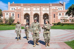 A general walks with ROTC leadership