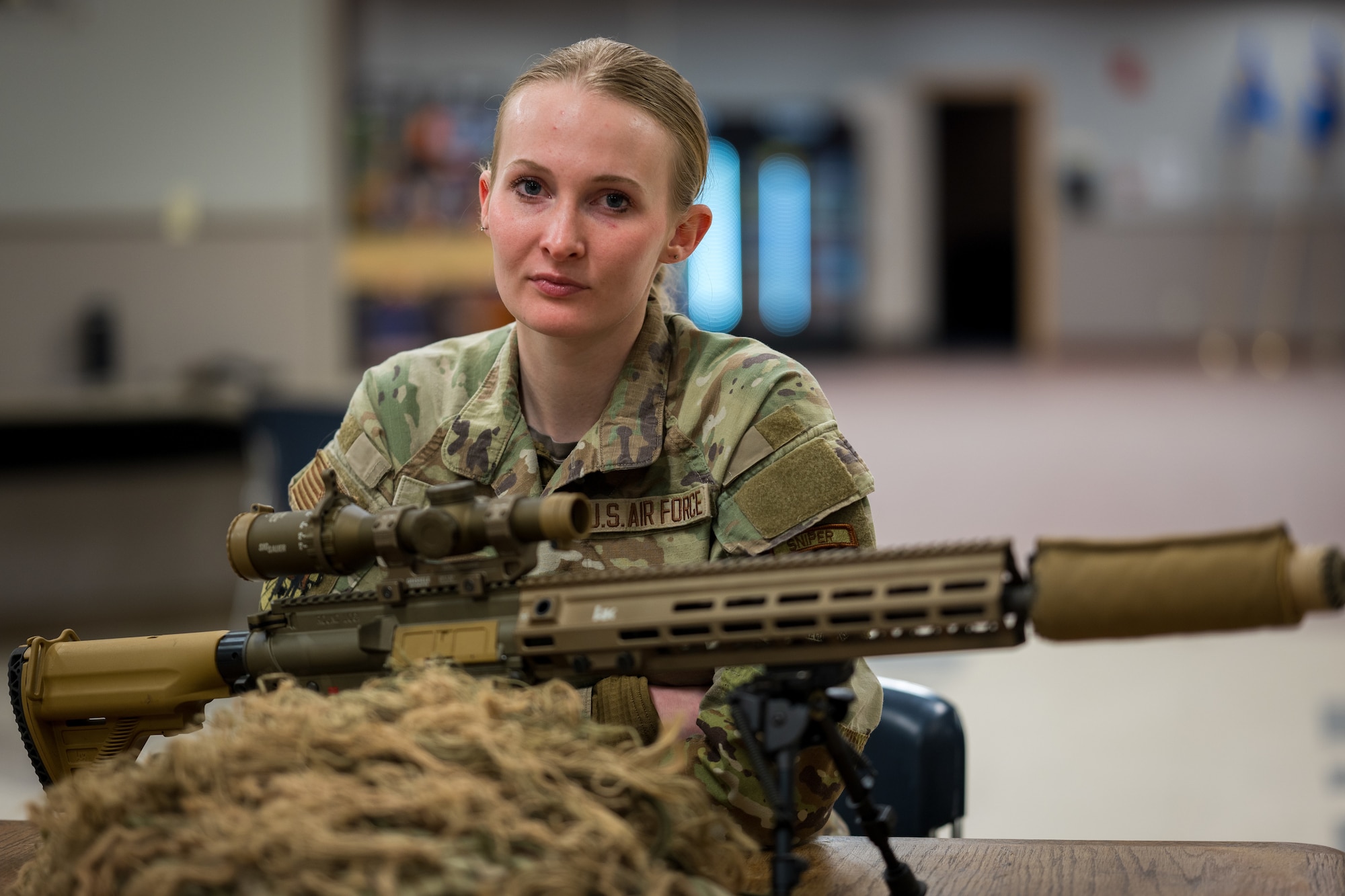 U.S. Air Force Senior Airman Samantha Karnes, 509th Security Forces Squadron defender, poses with a M110A1 Squad Designated Marksman Rifle on Whiteman Air Force Base, Missouri, February 21, 2025. Airmen who’ve passed the sniper engagement course can wear the sniper tab. (U.S. Air Force photo by Tech. Sgt. Nicholas Alder)