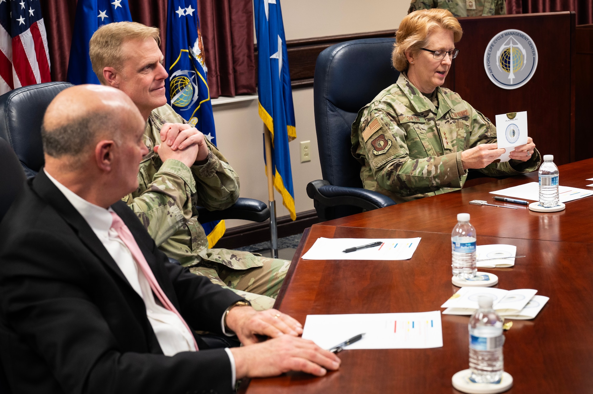 Lt. Gen. Donna Shipton (right), commander, Air Force Life Cycle Management Center, announces one of the award winners during the AFLCMC Annual Awards Ceremony held at Wright-Patterson Air Force Base, Ohio, Feb. 27, 2025. Looking on is the Center’s command chief, Chief Master Sgt. Timothy Wieser (center) and the  Center’s executive director Dennis D’Angelo. The ceremony was held virtually so all of the Center’s various organizations located throughout the country could participate. (U.S. Air Force photo by Jim Varhegyi)