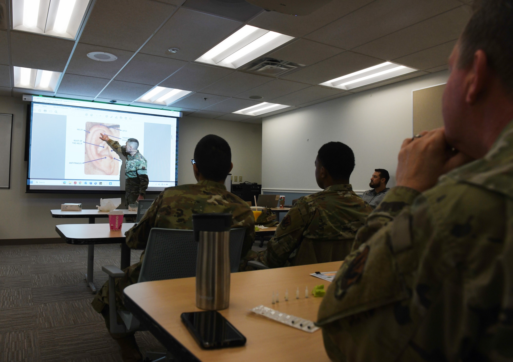 Lt. Col. Cagle points to a slide in the front of a class