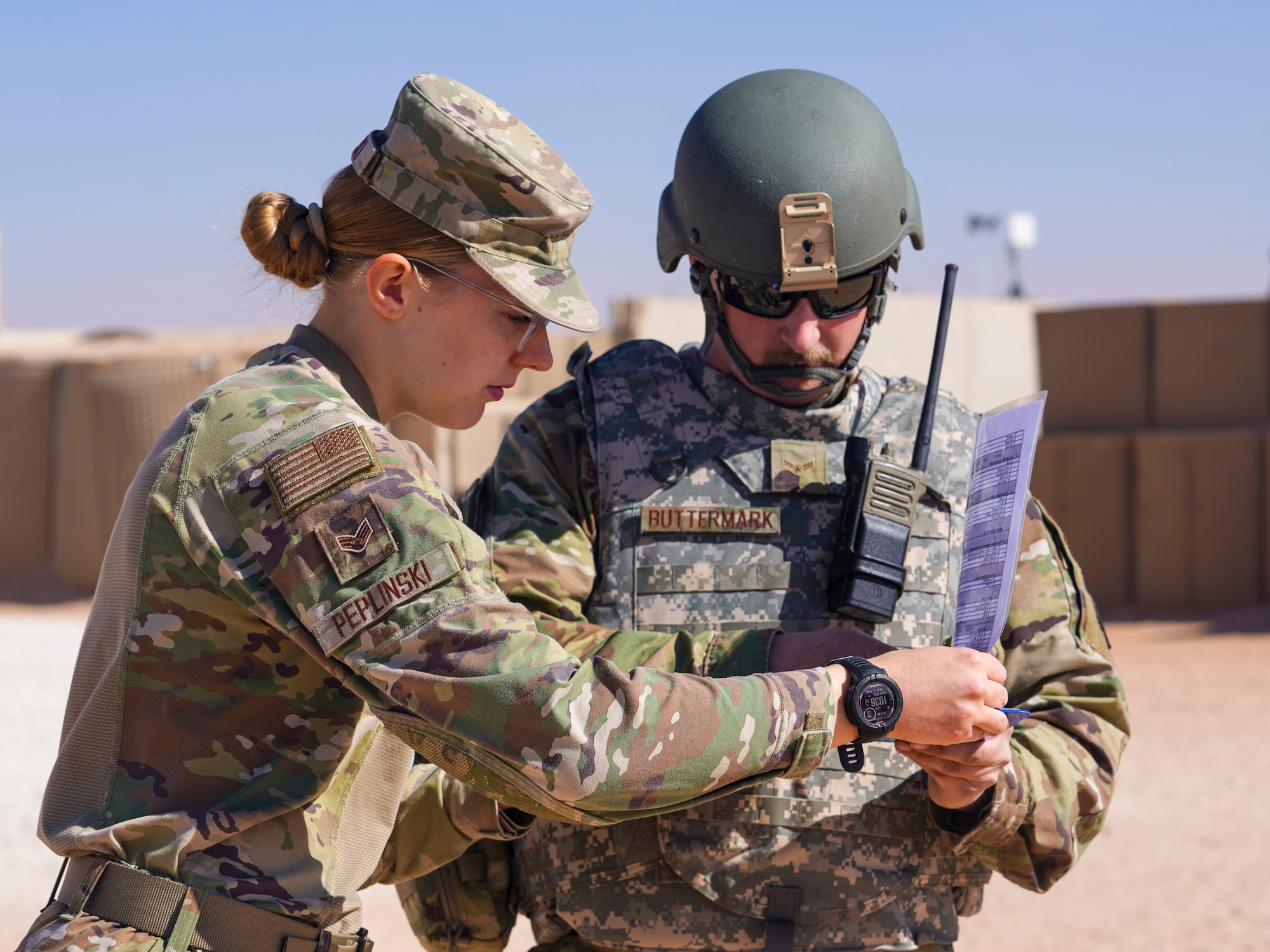 An emergency management specialist assigned to the 378th Expeditionary Civil Engineer Squadron assists an aircraft fuel systems journyeman in properly documenting observations during a post-attack reconnaissance (PAR) rodeo, Dec. 13, 2024, in the U.S. Central Command area of responsibility.