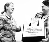 Chief Warrant Officer Amanda Madsen presents Gina Dickerson with an aptly labeled gift bag during Gina's retirement ceremony.