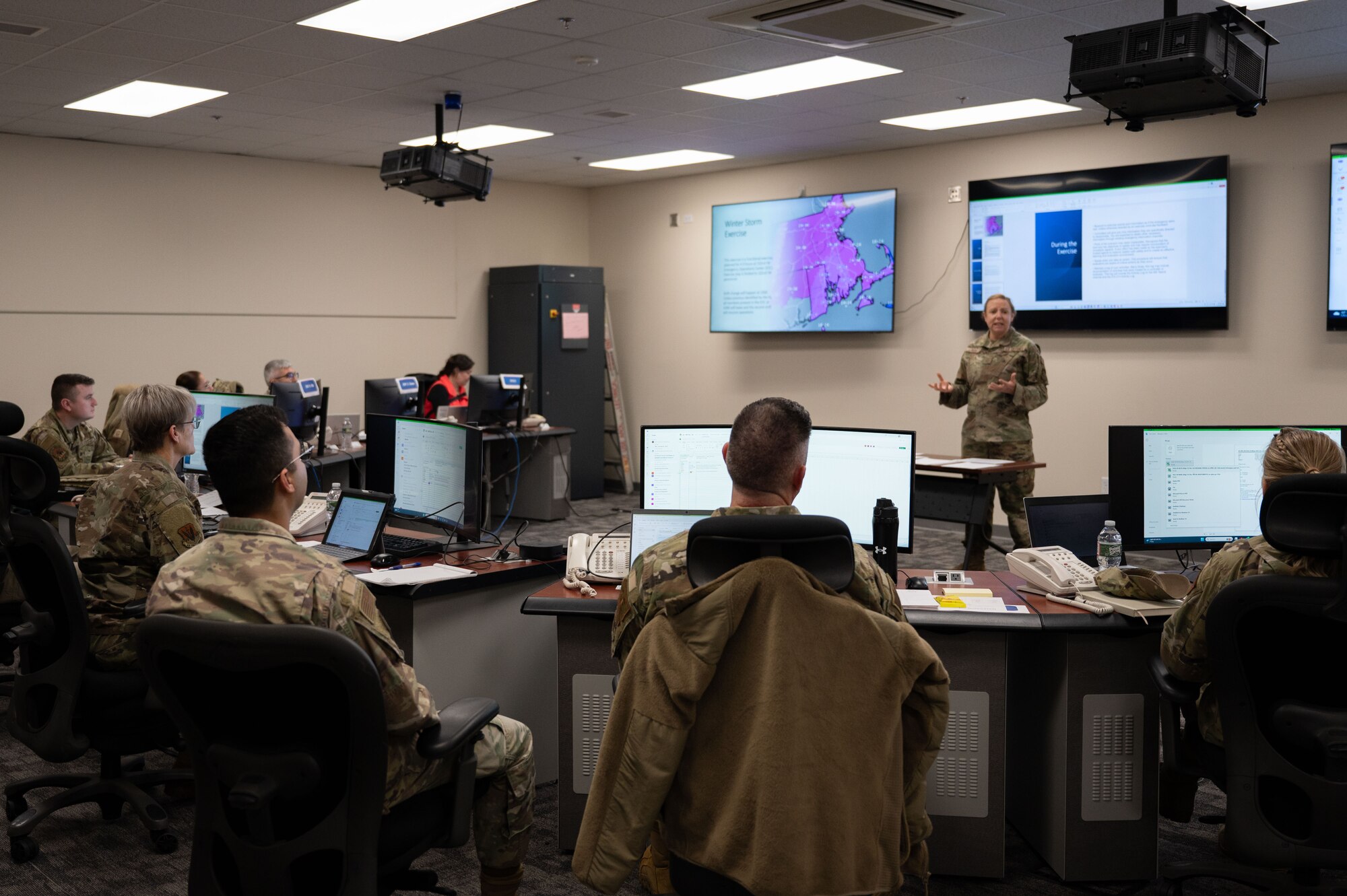 Airman speaks to multiple members in EOC.
