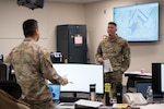 U.S. Air Force Lt. Col. Jeffery Andrieu, 102nd Civil Engineer Squadron commander, asks for updates from each member in the Emergency Operations Center during a natural disaster exercise on Otis Air National Guard Base, Massachusetts, Dec. 18, 2024.
