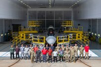 U.S. Air Force, Air National Guard and contract personnel pose in front of their custom-designed F-22 Raptor maintenance stands Sept. 26, 2024, at Joint Base Pearl Harbor-Hickam..The specialized maintenance stands are the culmination of nearly five years of collaboration between Total Force Airmen and the National Guard Bureau, providing a safer and more efficient way to access the hard-to-reach areas of one of the world’s most advanced stealth aircraft.