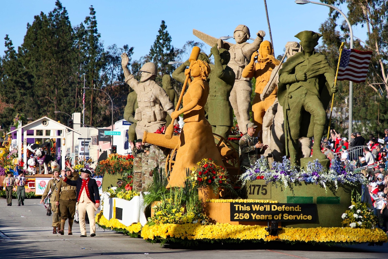 A parade float with large statues of soldiers rolls down a parade street.