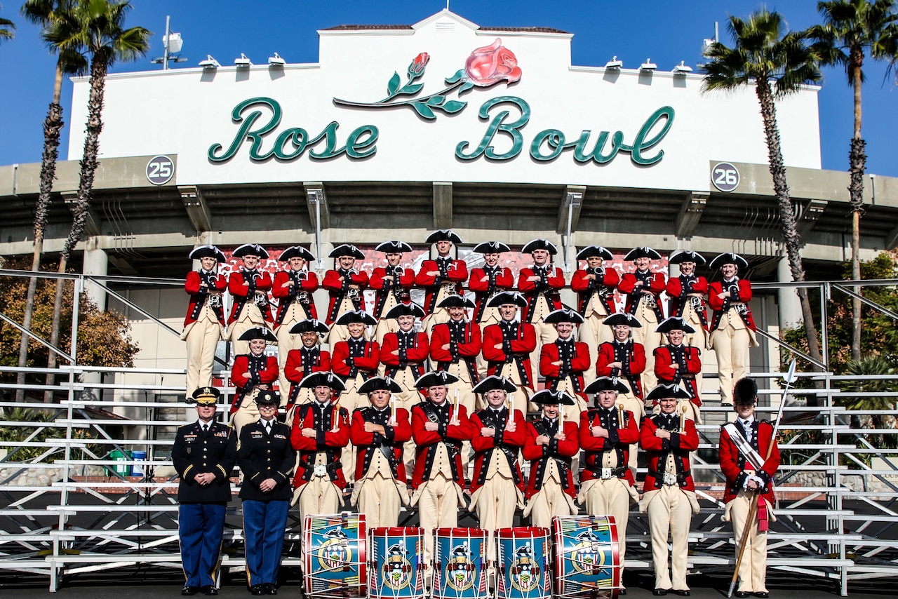 Old guard soldiers pose for a photo standing in bleachers in front of the Rose Bowl stadium entrance.