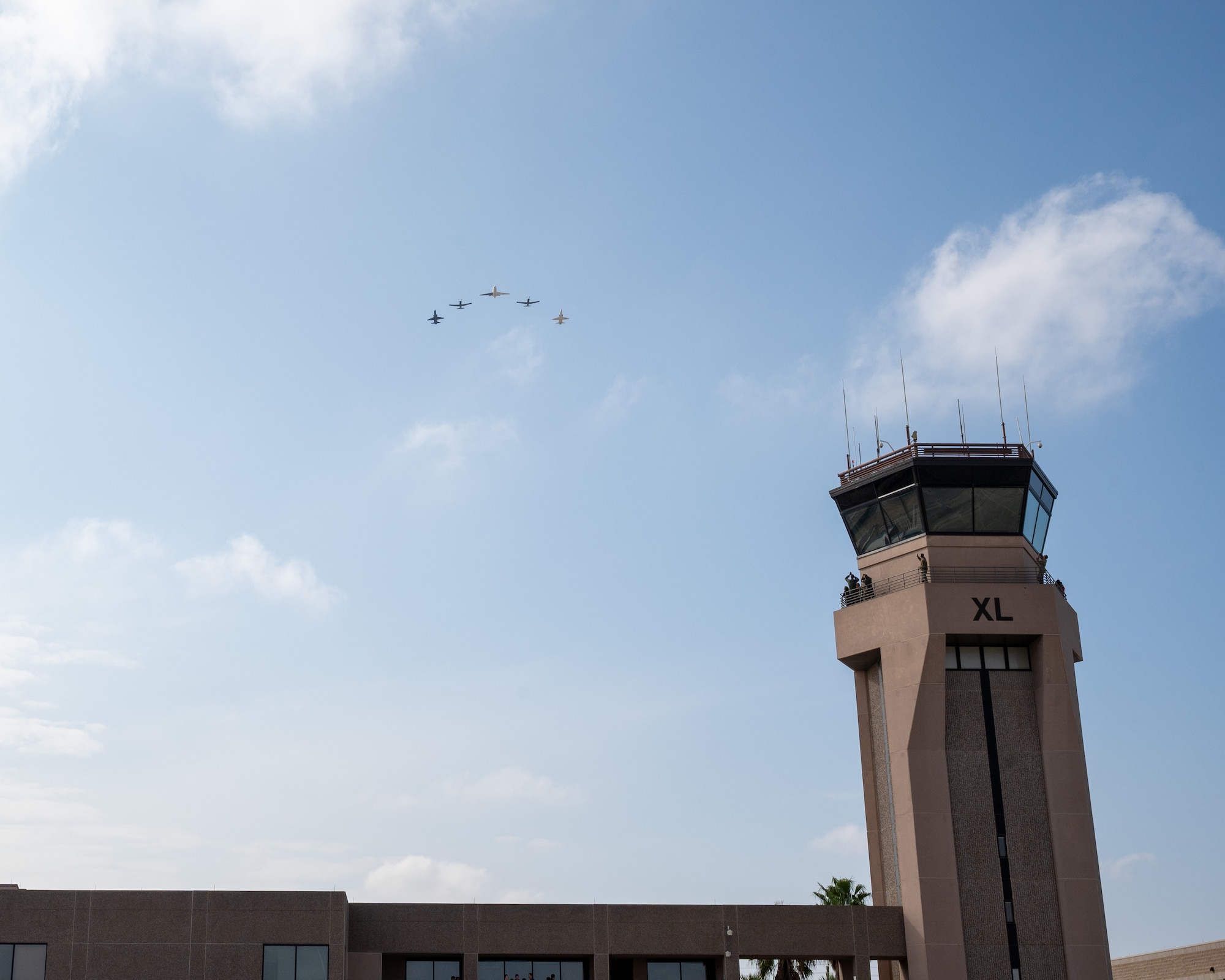 A five-ship formation flies over the Air Traffic Control (ATC) tower Laughlin at Air Force Base, Texas, Dec. 17, 2024. The final flight of the T-1A at Laughlin consisted of two T-6A Texan IIs, two T-38C Talons, and the final T-1A Jayhawk. (U.S. Air Force photo by Staff Sgt. Nicholas Larsen)