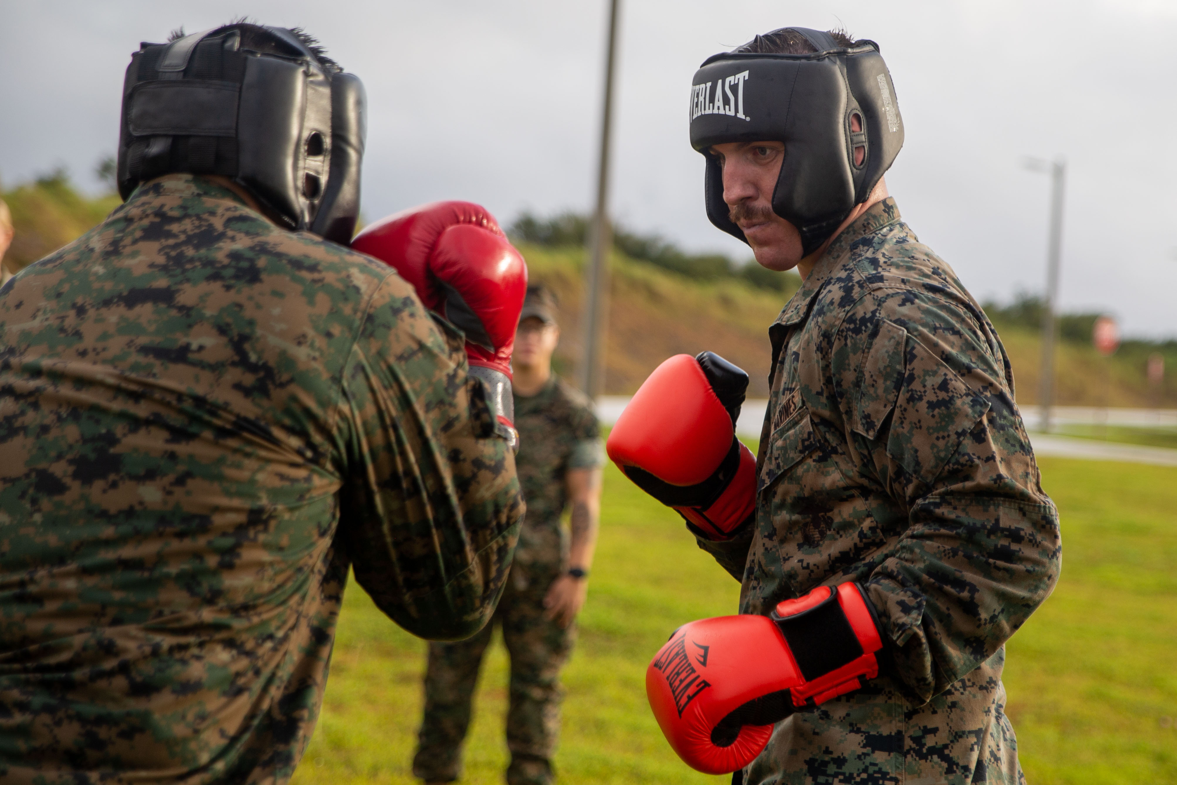 U.S. Marine Corps Staff Sgt. Kyle Althoff, communications maintenance chief, Marine Corps Base Camp Blaz, participates in body sparring as a part of unit physical training on Andersen Air Force Base, Guam, Dec. 18, 2024. Service members participated in combat conditioning and four physical bouts to foster teamwork, to enhance unit cohesion, and to promote physical training through competition. (U.S. Marine Corps photo by Lance Cpl. Afton Smiley)