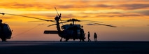 Sailors prepare an MH-60S Sea Hawk helicopter, attached to Helicopter Sea Combat Squadron (HSC) 14, to takeoff from the flight deck of the Nimitz-class aircraft carrier USS Abraham Lincoln (CVN 72).