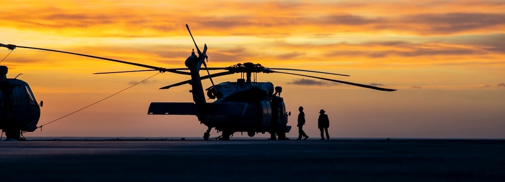 Sailors prepare an MH-60S Sea Hawk helicopter, attached to Helicopter Sea Combat Squadron (HSC) 14, to takeoff from the flight deck of the Nimitz-class aircraft carrier USS Abraham Lincoln (CVN 72).