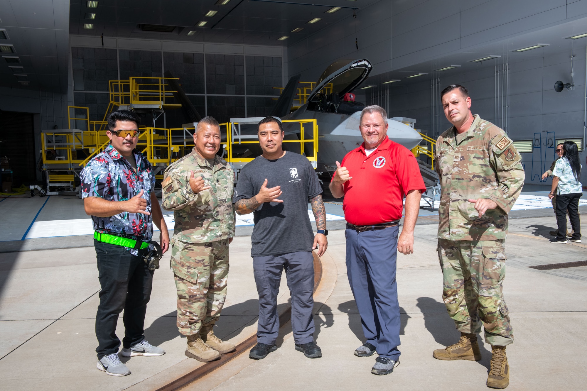 A team comprising U.S. Air Force, Air National Guard and contract personnel pose in front of their custom-designed F-22 Raptor maintenance stands during the debut event Sept. 26, 2024, at Joint Base Pearl Harbor-Hickam. The specialized maintenance stands are the culmination of nearly five years of collaboration between Total Force Airmen and the National Guard Bureau, providing a safer and more efficient way to access the hard-to-reach areas of one of the world’s most advanced stealth aircraft.