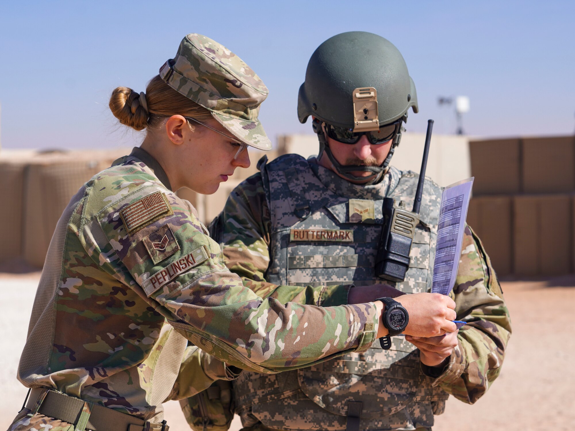 An emergency management specialist assigned to the 378th Expeditionary Civil Engineer Squadron assists an aircraft fuel systems journyeman in properly documenting observations during a post-attack reconnaissance (PAR) rodeo, Dec. 13, 2024, in the U.S. Central Command area of responsibility.