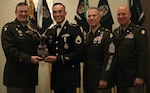 Brig. Gen. Lenny Williams, the assistant adjutant general - Army of the Illinois National Guard and the commander of the Illinois Army National Guard, State Command Sgt. Maj. Michael Kelly, and State Command Chief Warrant Officer CW5 Thomas Black present Staff Sgt. Francisco Orozco with an award at the Illinois Army National Guard's Recruiting and Retention Battalion's annual awards banquet Nov.16, 2024, in Peoria. Orozco was the Illinois Army National Guard's Recruiting and Retention Noncommissioned Officer of the Year with 35 enlistments.