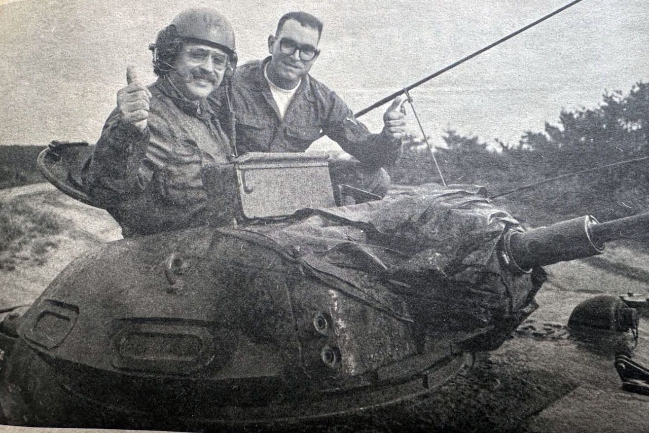 Men in a tank traverse the terrain.