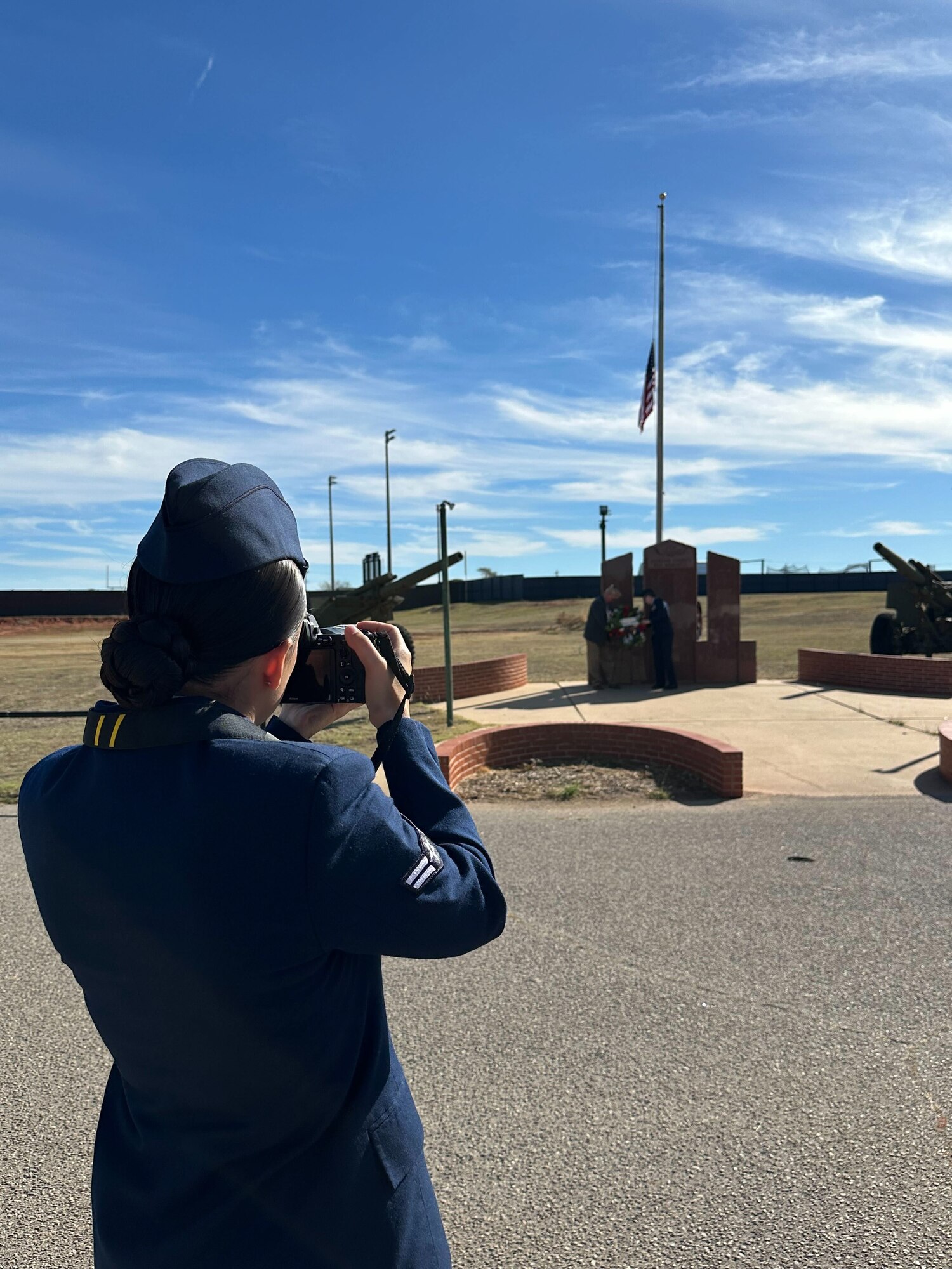 U.S. Air Force Airman 1st Class Lauren Torres, 97th Air Mobility Wing Public Affairs apprentice, takes a photo of the Jackson County War Memorial during Veterans Day at Altus, Oklahoma, Nov. 11, 2024. Torres helps ensure the public, the media, and internal stakeholders understand Altus Air Force Base’s mission, achievements, and values. (courtesy photo)