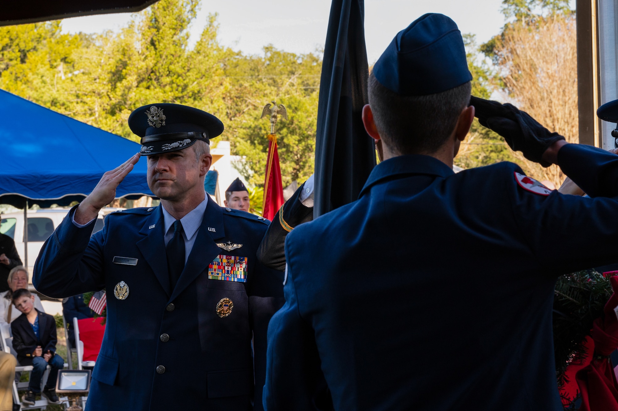 U.S. Air Force Col. Kaveri Crum, 1st Special Operations Wing deputy commander, salutes during the National Anthem at a Wreaths Across America Placement Ceremony at Beal Memorial Cemetery, Florida, Dec. 14, 2024.