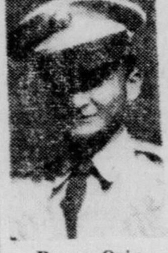 A man poses for a portrait photo wearing combat uniform.