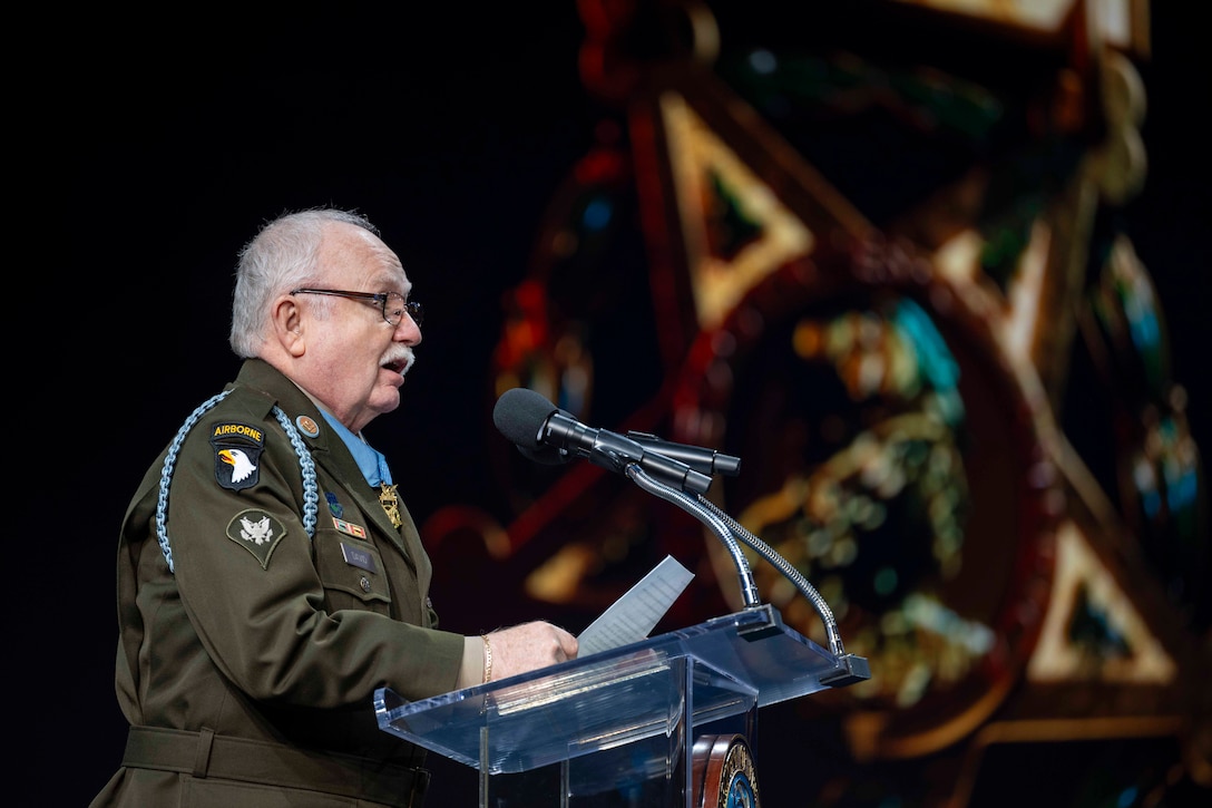 A Medal of Honor recipient delivers a speech from a lectern.