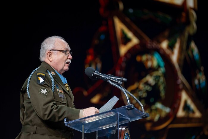 A Medal of Honor recipient delivers a speech from a lectern.