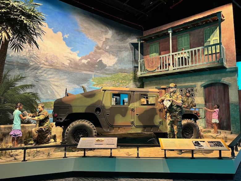 A restored Humvee, brought back to life by Marine Depot Maintenance Command (MDMC), stands at the center of this display, depicting Marines in Haiti during Operation Uphold Democracy.