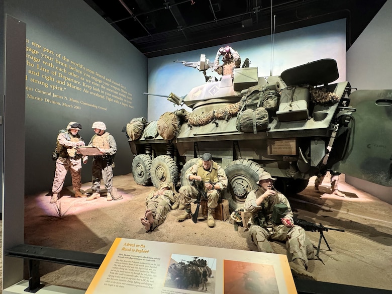 A restored Light Armored Vehicle (LAV) stands at the heart of the exhibit, 'A Break on the March to Baghdad,' showcasing the courage and determination of Marines during the 2003 Iraq invasion. National Museum of the Marine Corps.