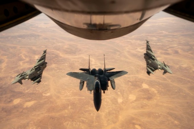 A U.S. Air Force F-15E Strike Eagle and Royal Air Force Eurofighter Typhoon FGR4s fly over the U.S. Central Command area of responsibility during exercise Yellow Sands. The Yellow Sands series of exercises include a Combined Integrated Air and Missile Defense program focused on the combined defense of the Arabian Peninsula.