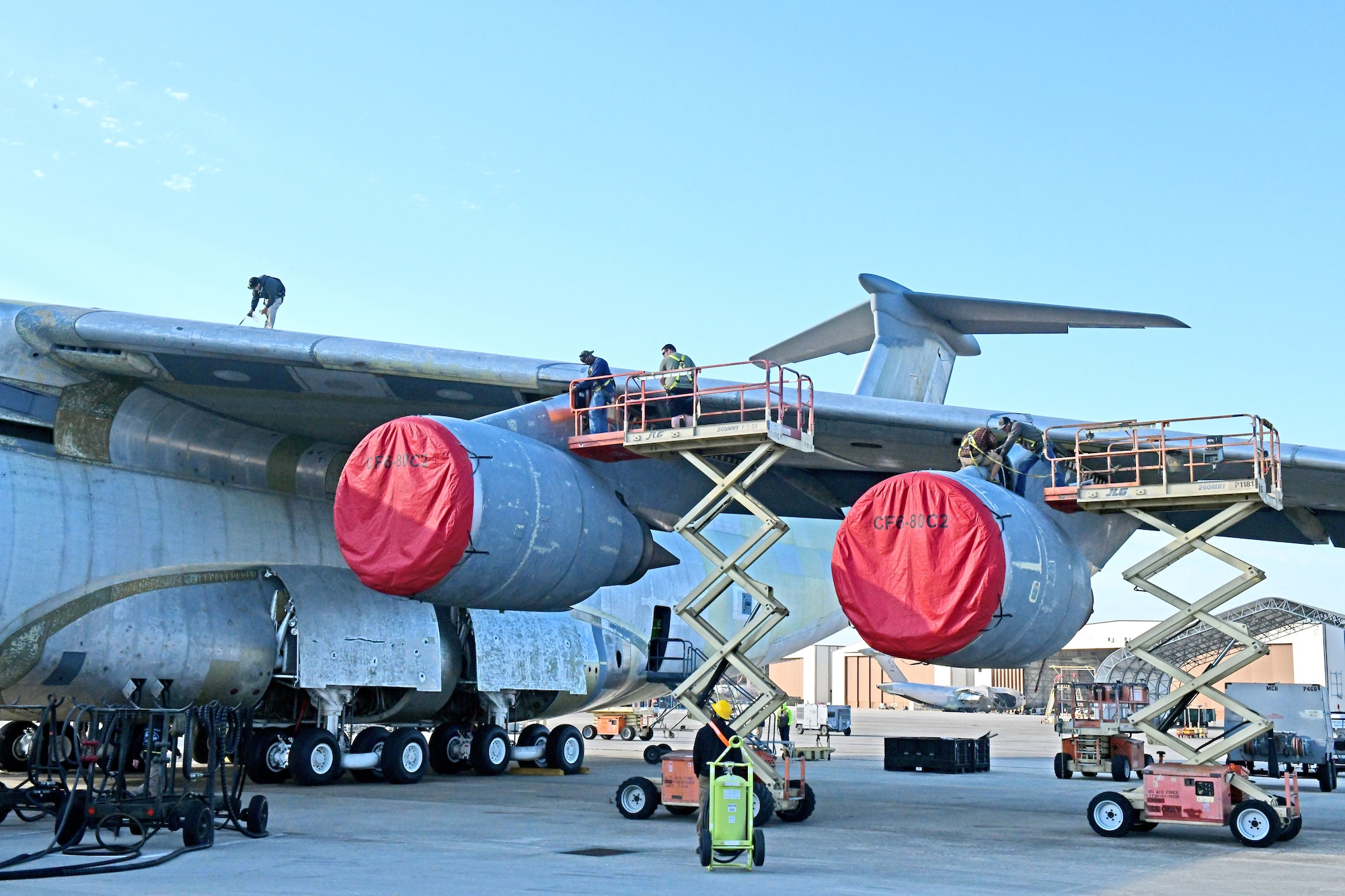 Aircraft mechanics working on airplane wing