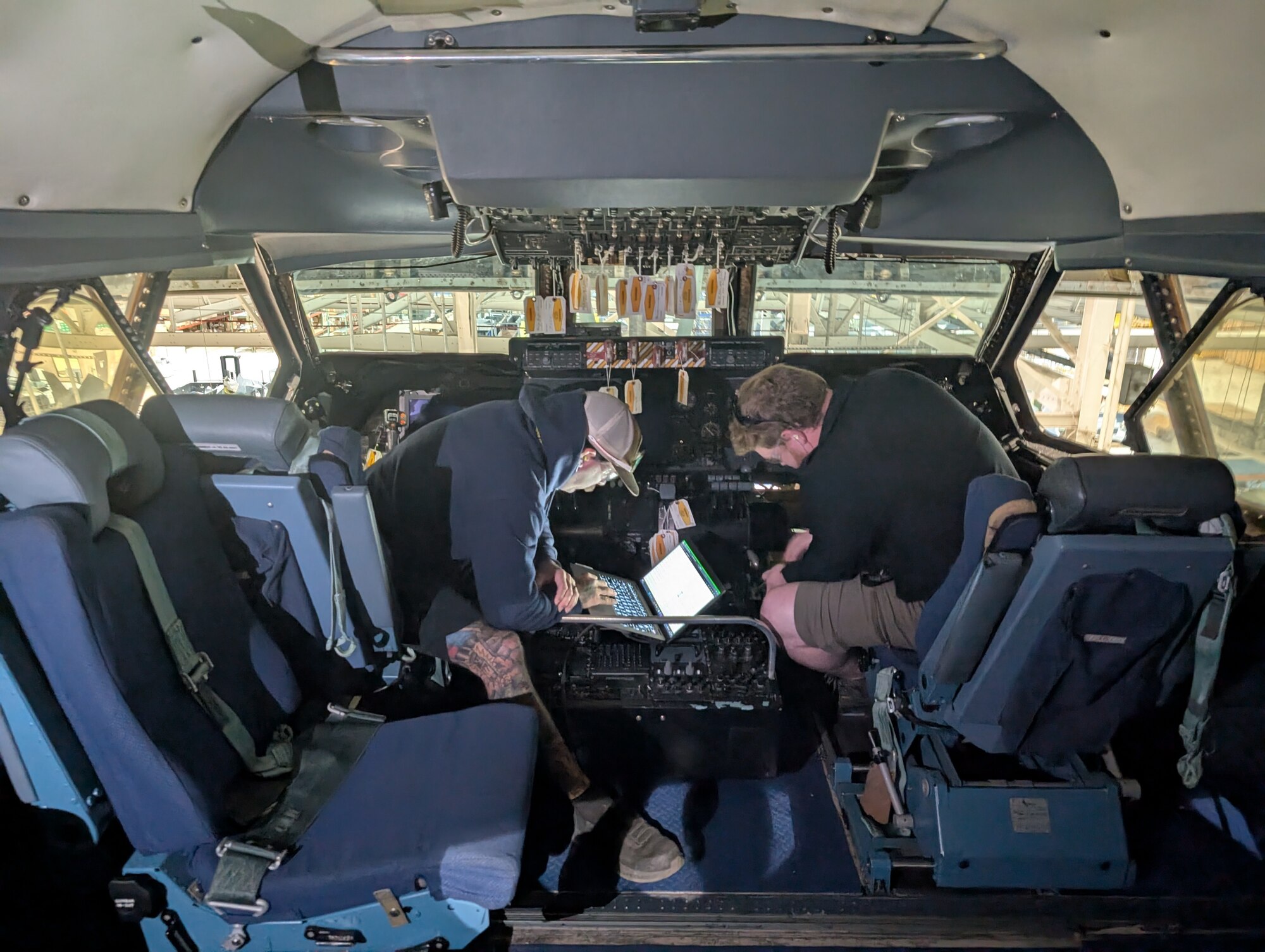 aircraft mechanics in aircraft cockpit