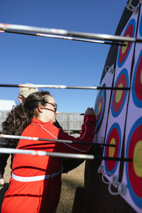 U.S. Marine Corps Staff Sgt. Ashley Lazareno, a recovering service member with Wounded Warrior Battalion-East (WWBn-E), marks shots on a target during the WWBn-E Mini-Trials on Marine Corps Base Camp Lejeune, North Carolina, Dec. 12, 2024. The WWBn-E Mini-Trials foster recovery and rehabilitation by encouraging adaptive sport participation, while also building camaraderie among recovering service members. This event provides an opportunity for participants to refine their skills and demonstrate their progress in a supportive yet competitive environment. (U.S. Marine Corps photo by Cpl. Loriann Dauscher)