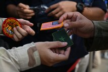 U.S. Air Force Airmen hand out patches to Vietnamese citizens at the Vietnam Defense Expo 2024 at the Gia Lam Airport, Dec. 21, 2024. The U.S. is an Indo-Pacific nation and will remain engaged in the region, securing every opportunity to train alongside our Allies and partners to build interoperability and bolster our collective ability to support a free and open Indo-Pacific. (U.S. Air Force photo by Capt. Casey Bell)