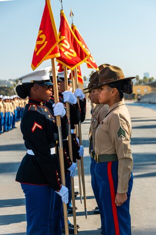 U.S. Marines with Fox Company, 2nd Recruit Training Battalion, exchange guidons during a graduation ceremony at Marine Corps Recruit Depot San Diego, California, Dec. 20, 2024. This ceremony marked the end of a 13-week transformation process that included training in drill, marksmanship, basic combat skills, and Marine Corps customs and traditions. (U.S. Marine Corps photo by Lance Cpl. Eric Valerio)