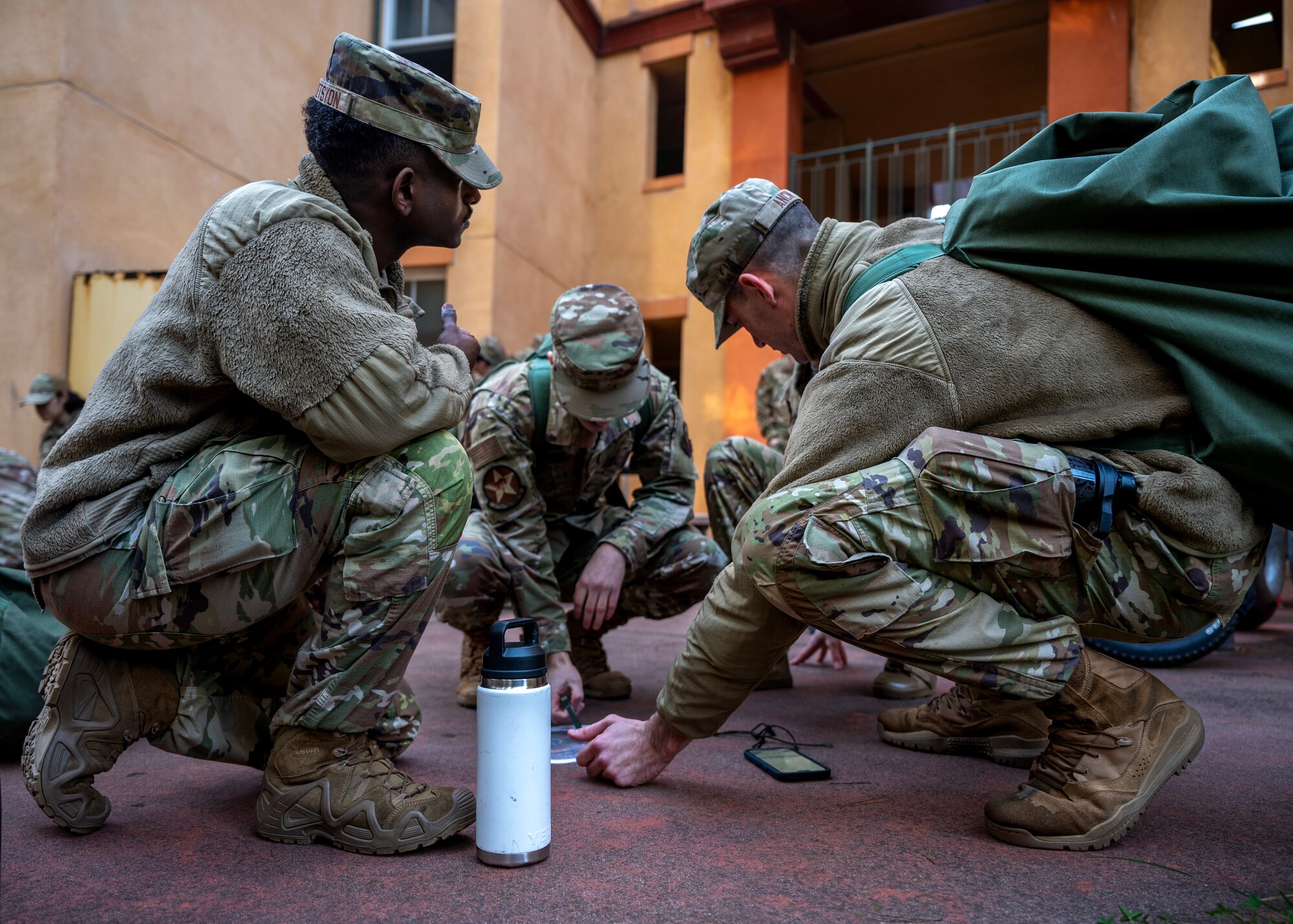 Airmen practice locating navigation points during survival, evasion, resistance, and escape training during a deployment readiness exercise, Presidio of Monterey, Calif., Jan. 6, 2025. SERE is a vital training that equips service members with essential skills to endure and operate in high-risk, hostile, or isolated environments. (U.S. Air Force photo by Senior Airman Sarah Williams)