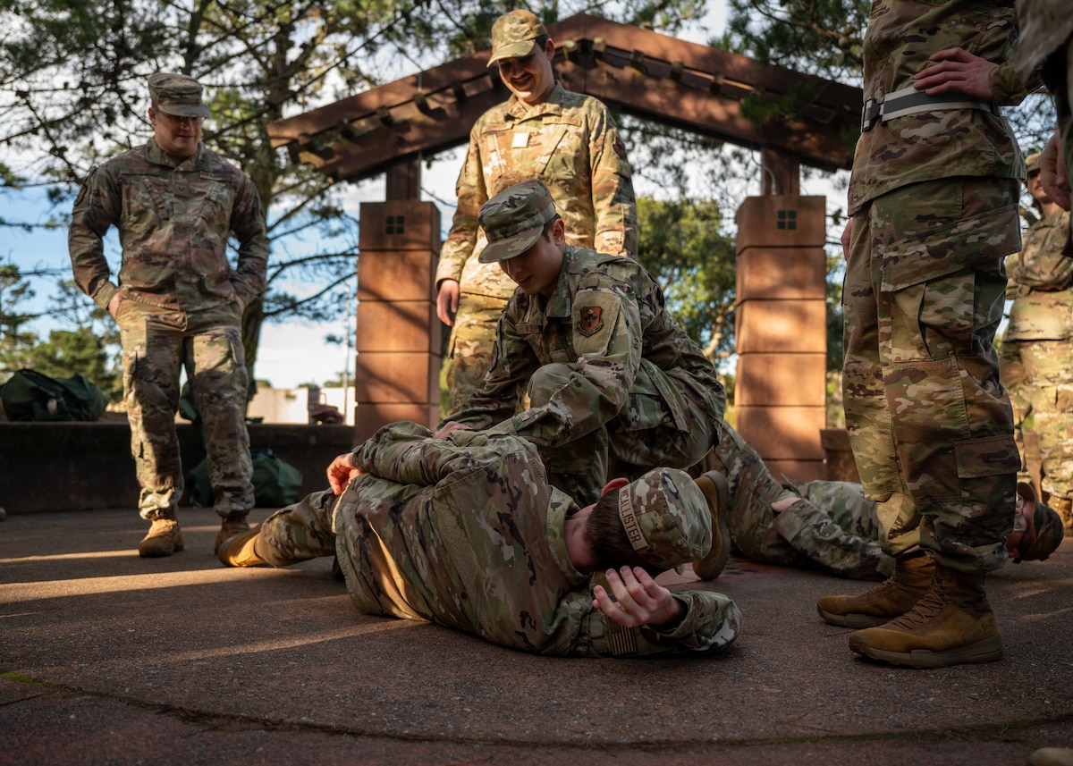 U.S. Air Force Airman Basic Ethan Wolffis, 311th Training Squadron student, practice tactical combat casualty care during a deployment readiness exercise, Presidio of Monterey, Calif., Jan. 6, 2025. TCCC emphasizes immediate, life-saving interventions such as controlling severe bleeding, managing airway obstructions, and treating chest injuries increasing survivalbility in the case of injury. (U.S. Air Force photo by Senior Airman Sarah Williams)