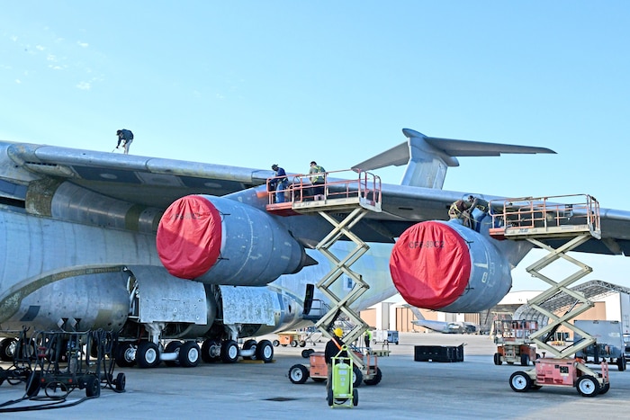 Aircraft mechanics working on airplane wing