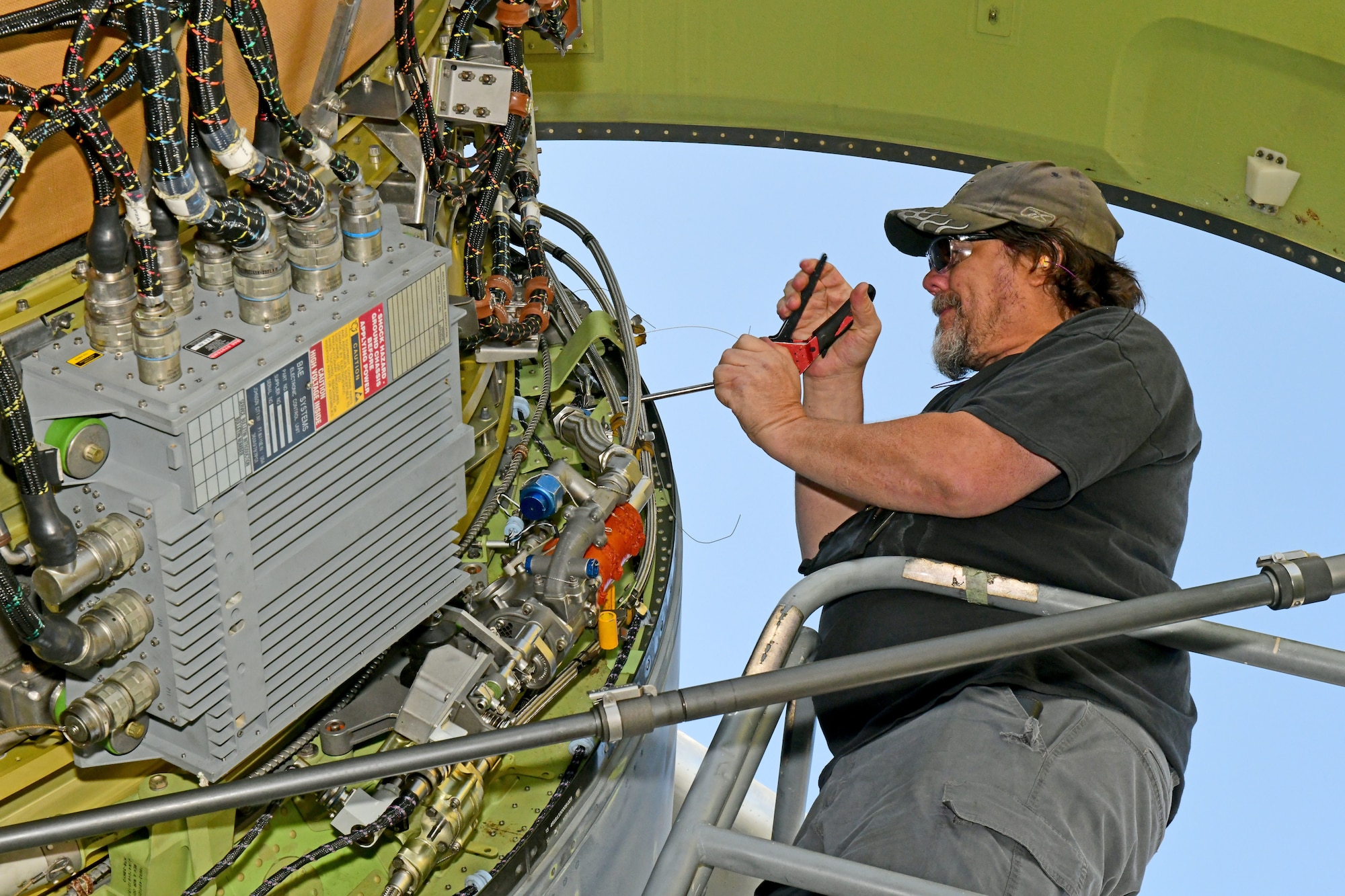 aircraft mechanic working on airplane engine