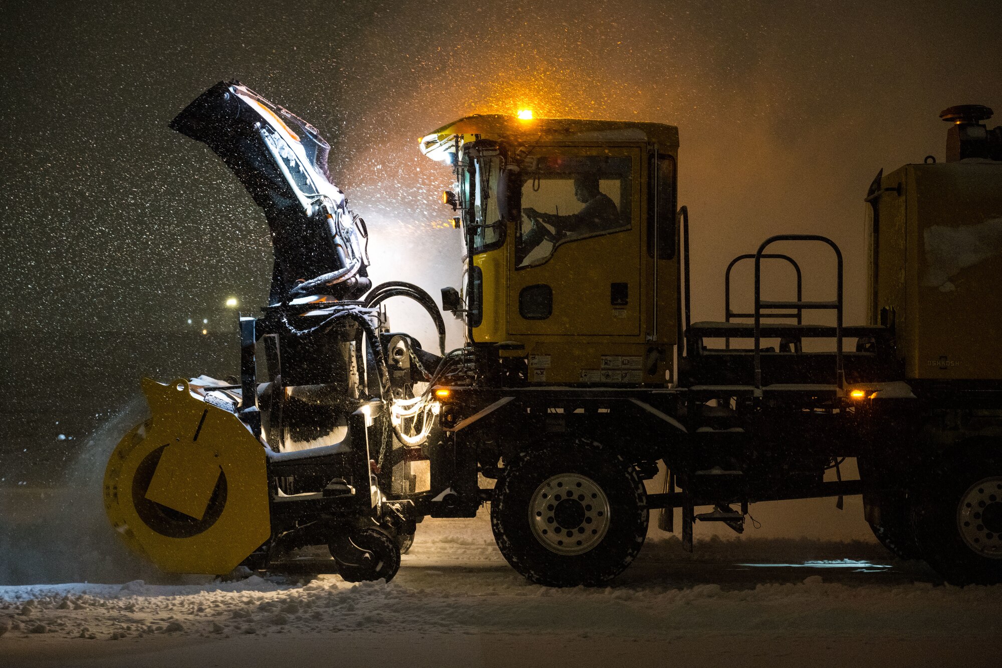 A member assigned to the 316th Civil Engineer Squadron operates a snow boom.