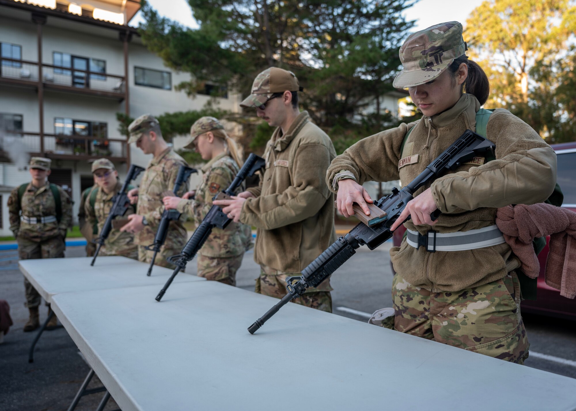 Airmen practice clearing an M4 rifle during a deployment readiness exercise, Presidio of Monterey, Calif., Jan. 6, 2025. Clearing an M4 rifle prevents accidental discharges and ensures that it is safe for use, storage, and transport. (U.S. Air Force photo by Senior Airman Sarah Williams)