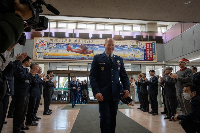 U.S. Air Force Lt. Gen. Stephen Jost, U.S. Forces Japan and 5th Air Force commander, receives a welcoming applause at Misawa City Hall in Misawa City, Japan, Dec. 16, 2024. The presence of the installation directly affects the local economy, culture, and daily life of community members. Regular engagement between the U.S. military and the local Japanese community fosters strong and positive relations by building mutual understanding, trust, and cooperation. (U.S. Air Force photo by Staff Sgt. Kelsea Caballero)