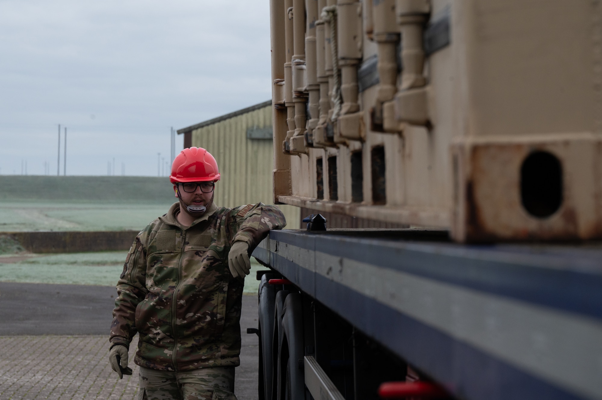 A service member from the 420th Munitions Squadron ensures the placement of cargo
