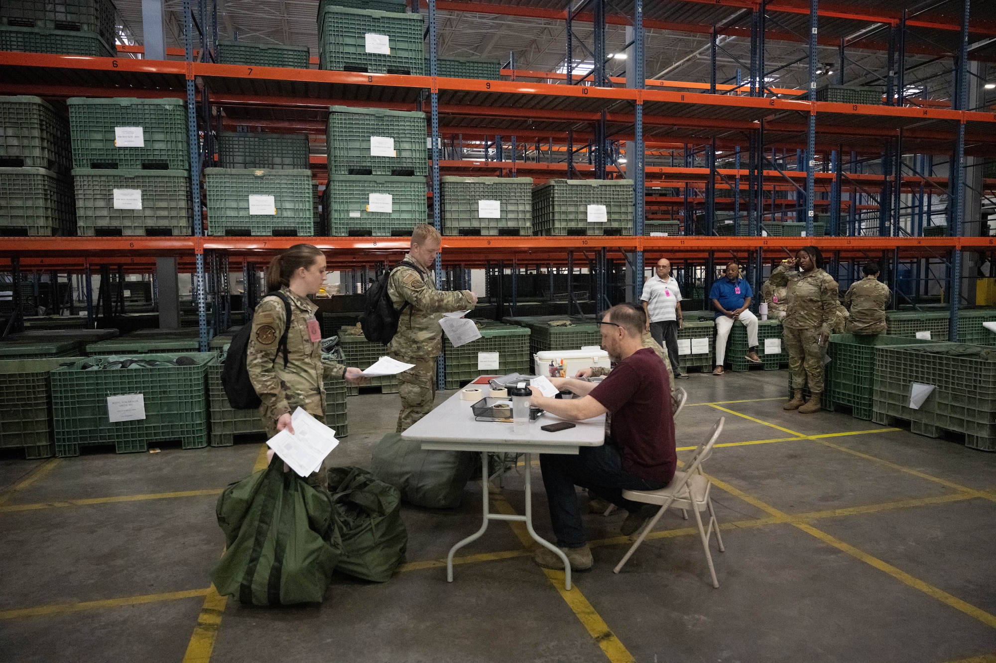 Two Airmen are checking their gear.