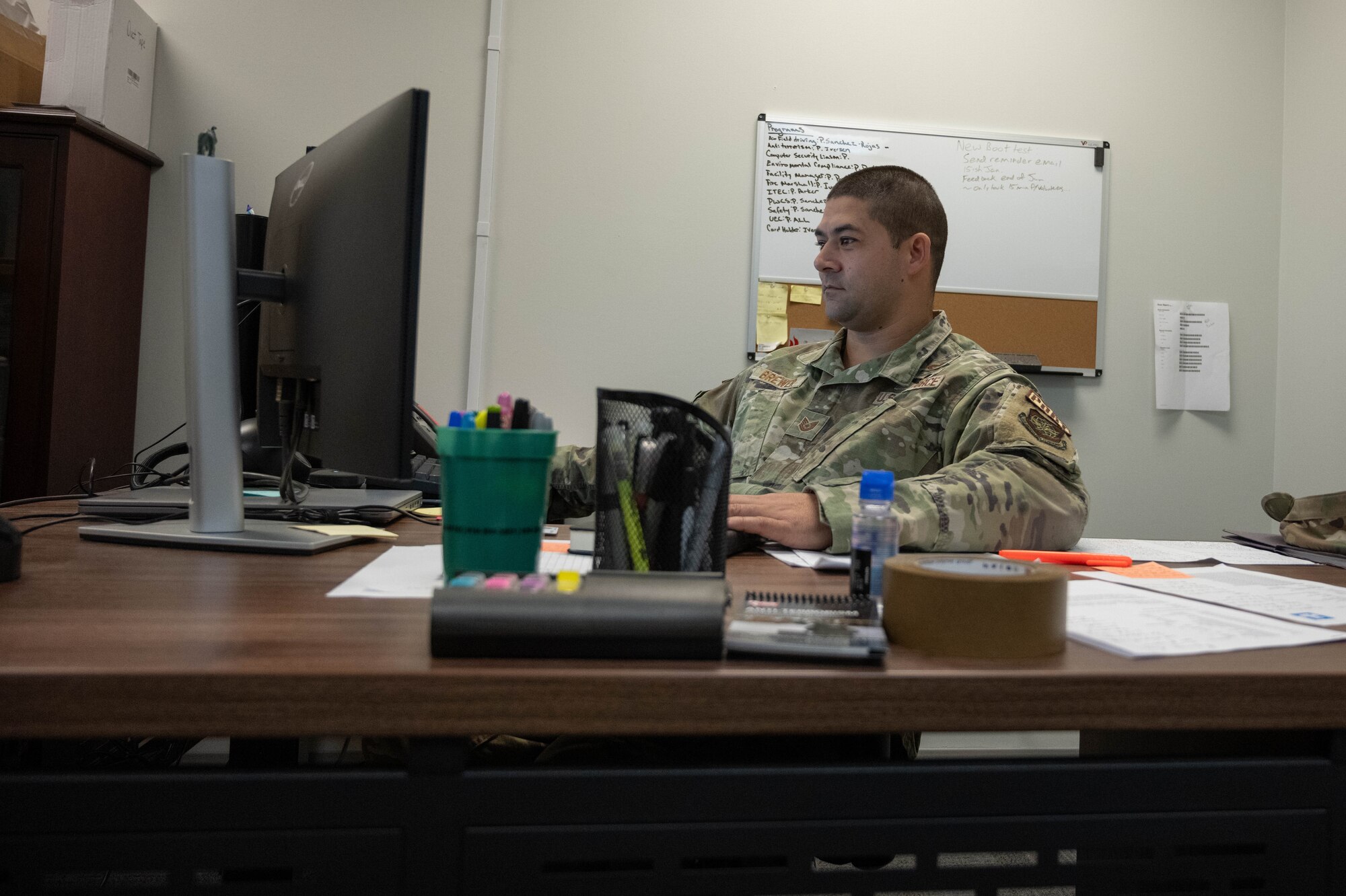 An Airman sits in front of a computer
