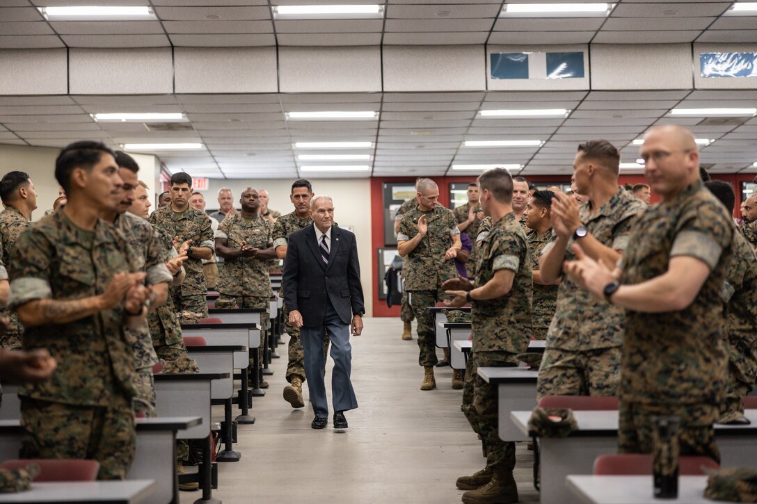 Retired U.S. Marine Corps Chief Warrant Officer 4 Gilbert H. Bolton, a Marine Gunner, walks toward the stage during an award ceremony at the School of Infantry West at Marine Corps Base Camp Pendleton, California, Aug. 22, 2024.  Bolton received a Presidential Lifetime Achievement Award for completing over 4,000 hours of service in his community.  Bolton retired on the first of October in 1991 after 32 years of honorable service. (U.S. Marine Corps photo by Lance Cpl. Mhecaela J. Watts)