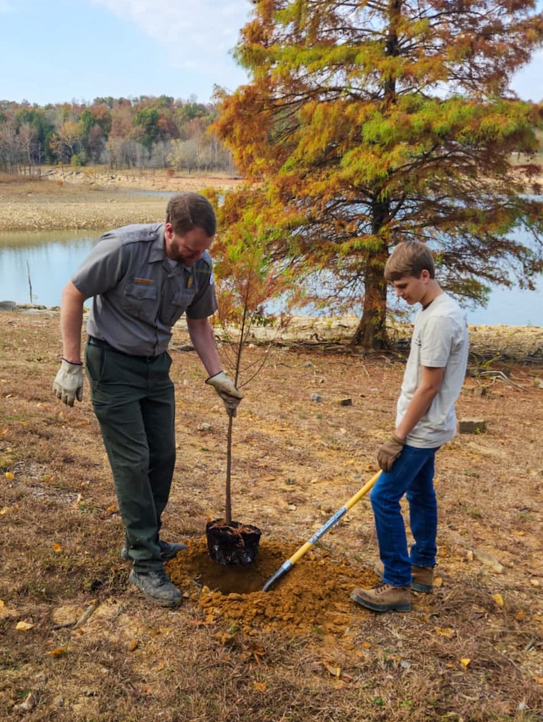 Adam Warren, Rough River Lake park ranger, and volunteer David Warren plant bald cypress trees on the banks of Rough River Lake, Falls of Rough, Ky.